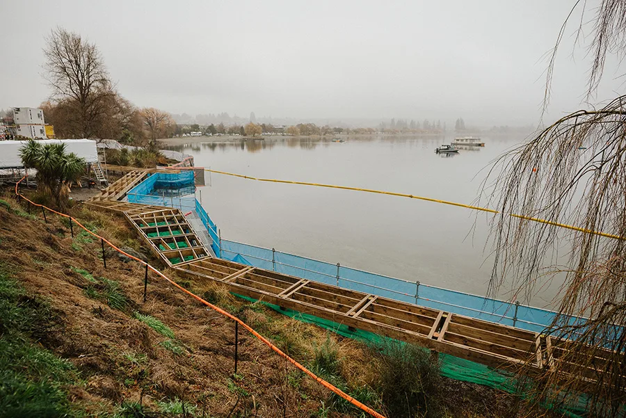 Construction of a new viewing platform and seating area along a lake's edge.