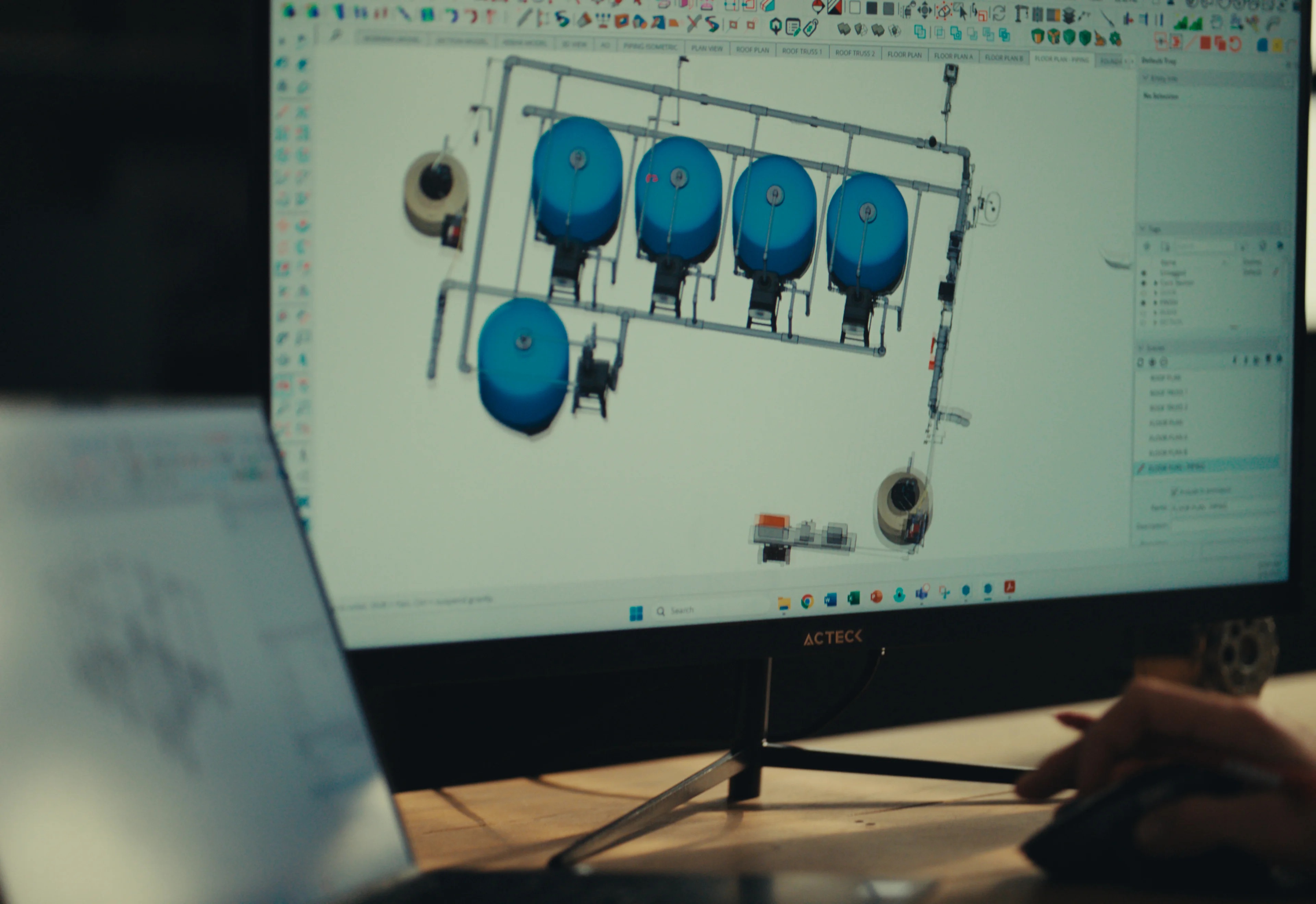 A computer screen shows a 3D model of a water system.