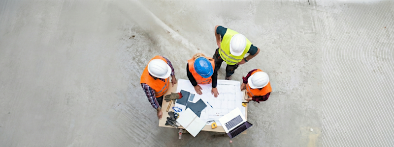 Construction team reviewing plans on site.