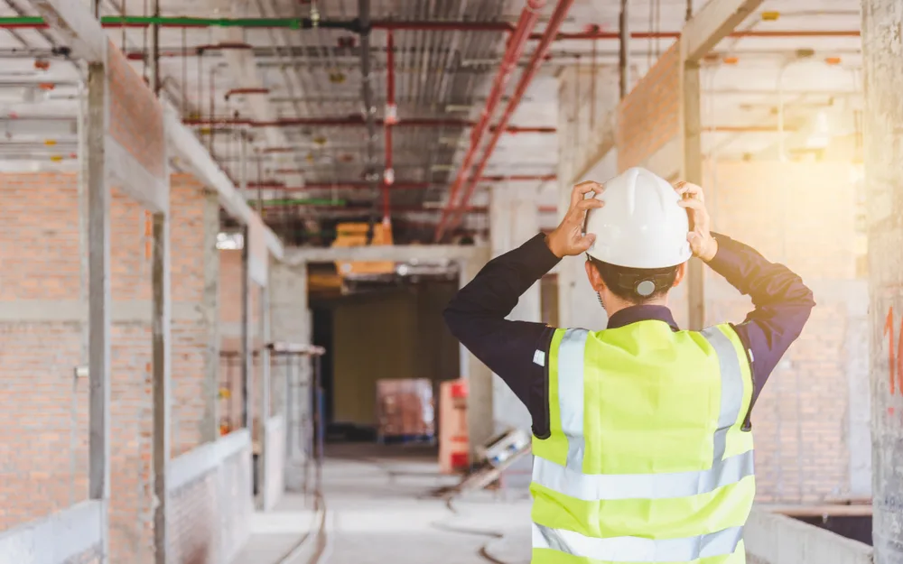Frustrated construction worker looking at structure