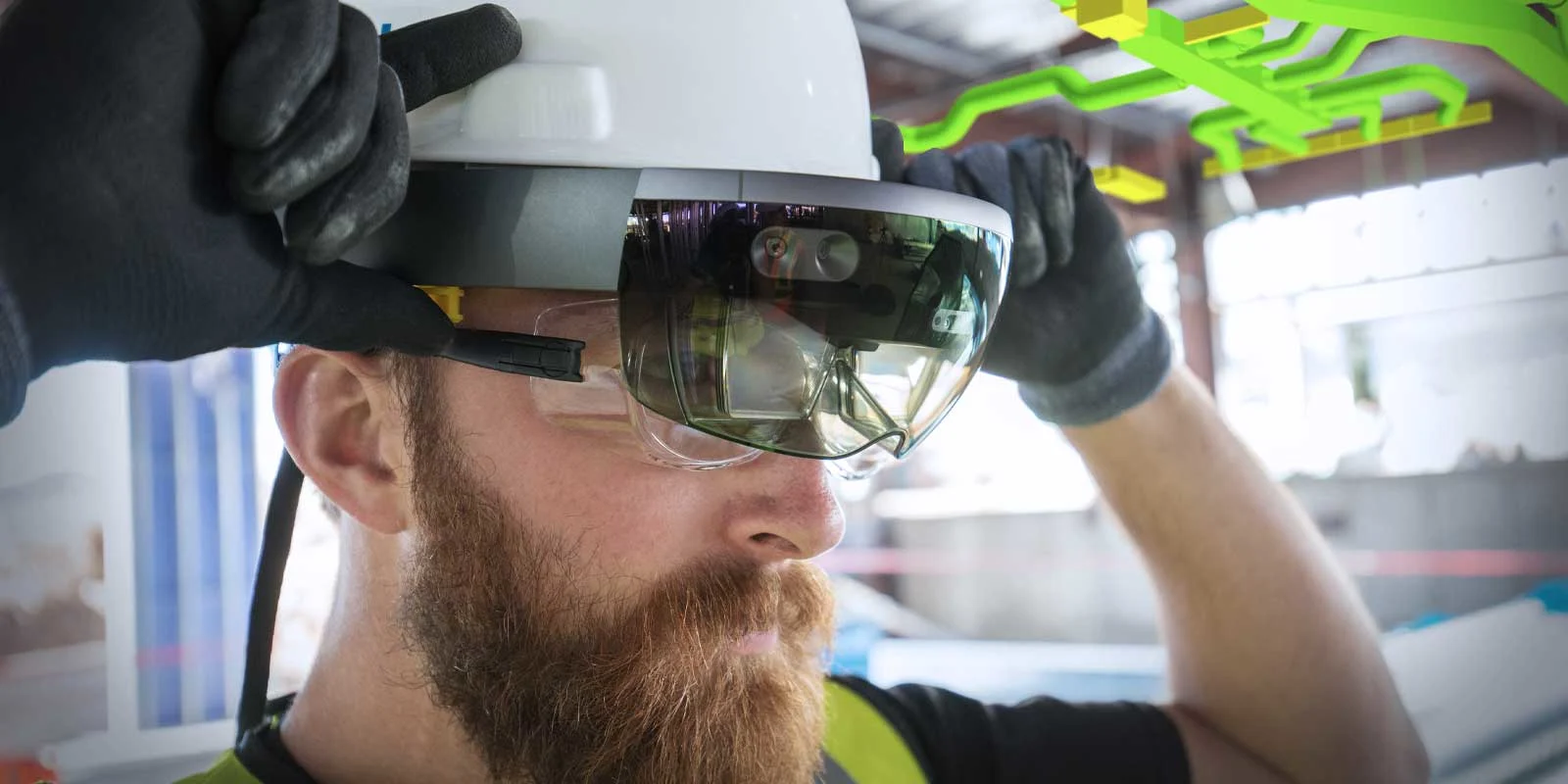 Construction worker wearing a hard hat and HoloLens headset with augmented reality overlay.