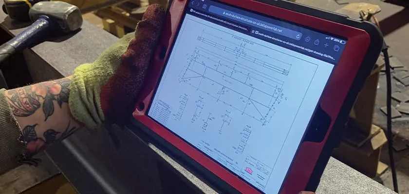 Through Tekla PowerFab, the fabricator accesses and views the drawing on their tablet