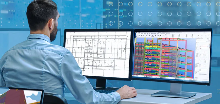 Engineer reviews 2D architectural plans and 3D building model on dual monitors.