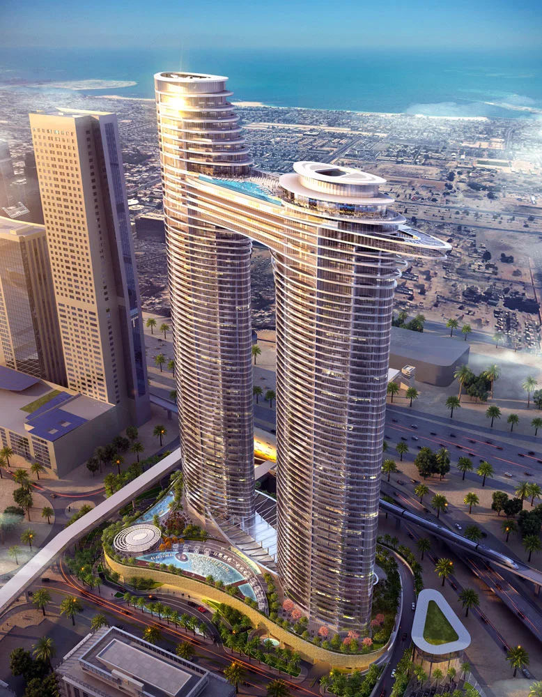 Aerial view of the SO/ Uptown Dubai Hotel and Residences featuring two intertwined towers connected by a sky bridge, a rooftop pool, and landscaping.