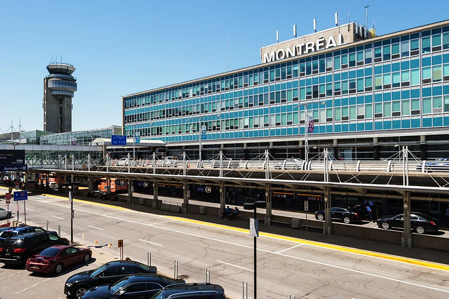Montreal-Trudeau International Airport with its distinctive control tower and blue-windowed terminal.