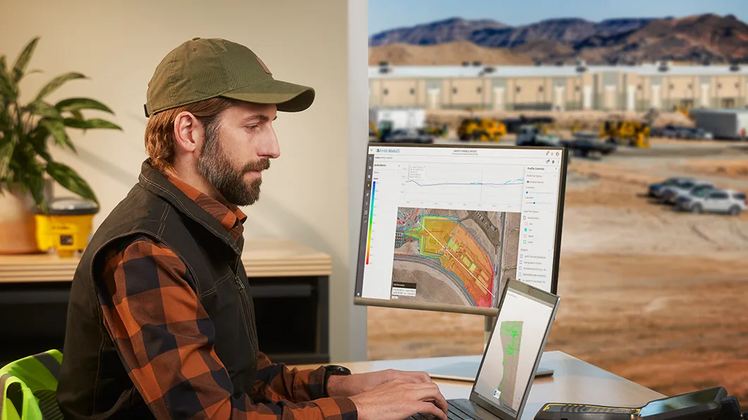 A site manager in the office processes site data on Trimble WorksManager and Trimble Business Center