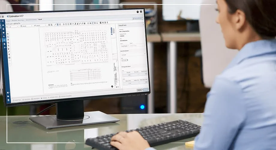 Woman using specialized software on a computer to analyze and estimate project data.