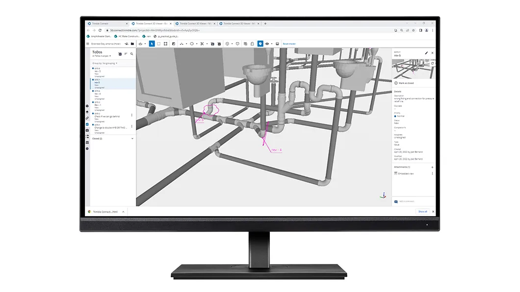 A desktop monitor showing 3D MEP piping models with revision callouts in Trimble Connect.