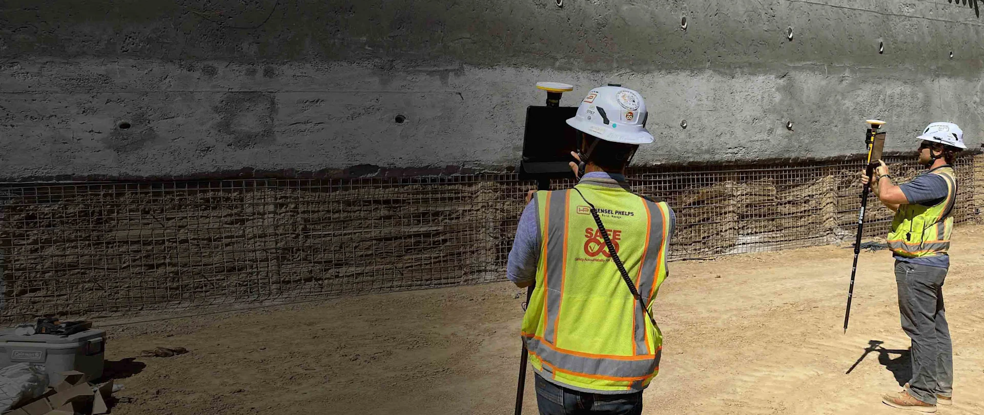 Construction workers using an augmented reality (AR) system on a job site.
