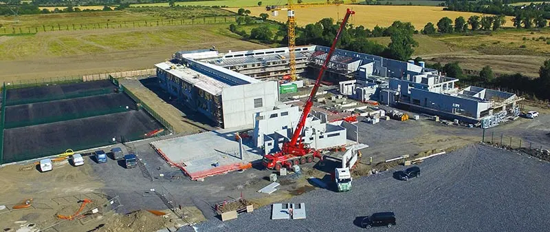 Aerial view of Tyrellstown National School construction site with cranes and partially built structures.