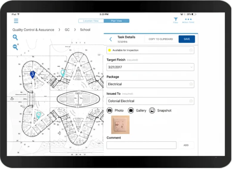 iPad screen showing construction management app with building floor plan and electrical inspection task details