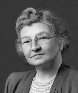Black and white portrait of a woman with glasses and styled hair.