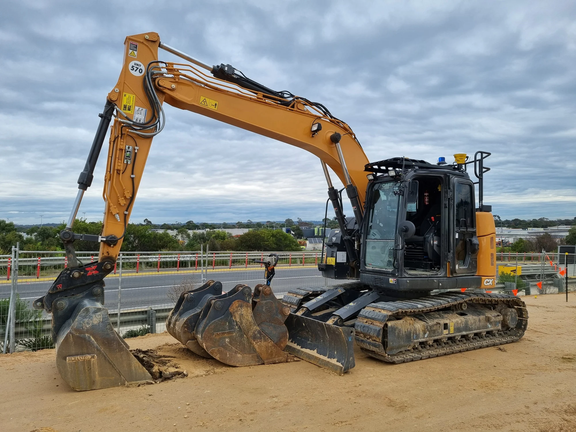 Excavator on left with in cab image on right