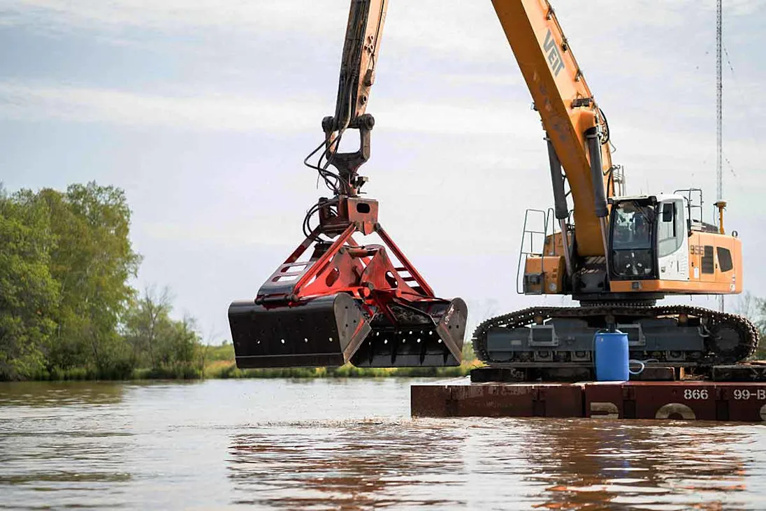 Excavator dredging