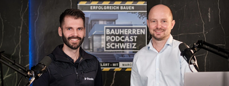 Hugo Rodrigues of Trimble and Marco Fehr Bauherren Podcast Schweiz in a podcast studio with microphones visible on both sides.