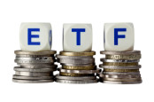 ETF Investing with ETF letters on coins.