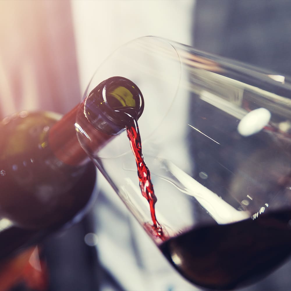 Close up of pouring a glass of red wine