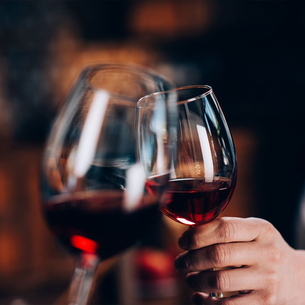 Cheersing two glasses of red wine