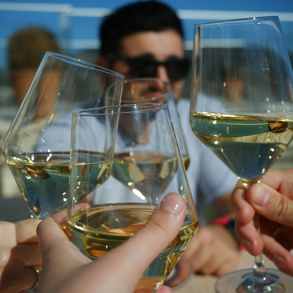 Close up of cheersing white wine