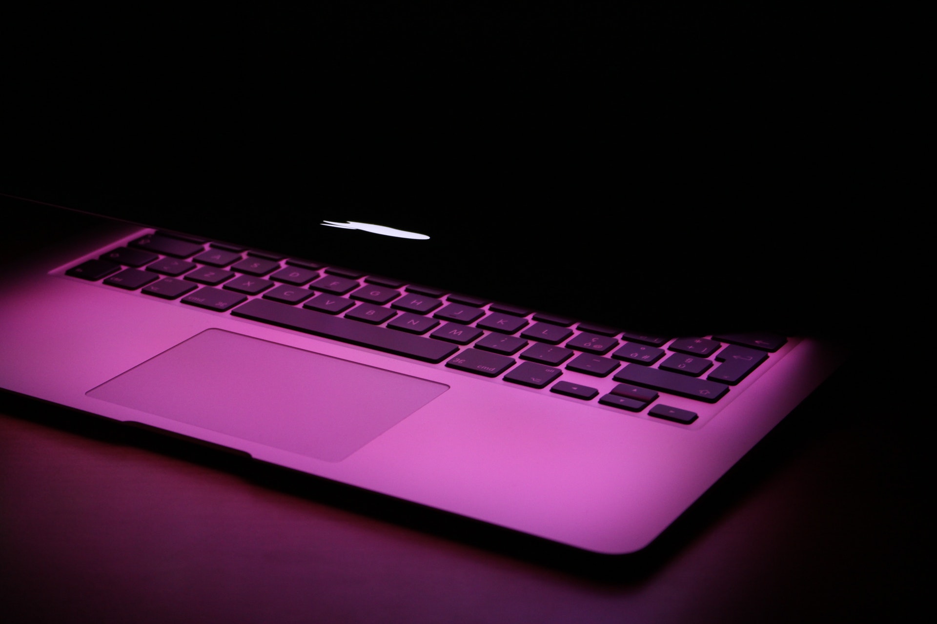 A Macbook Air with Purple Lighting