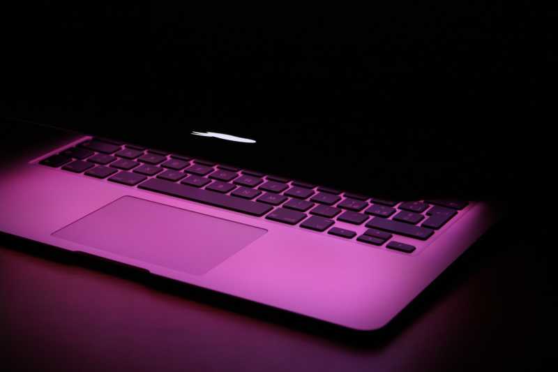 A Macbook Air with Purple Lighting