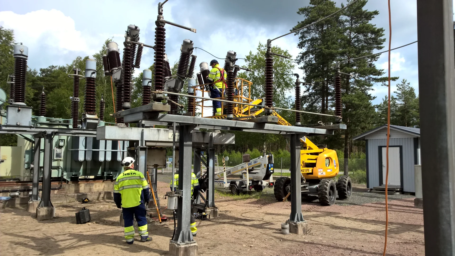 Employees of the Insta Electricity Distribution Unit working at a transformer.