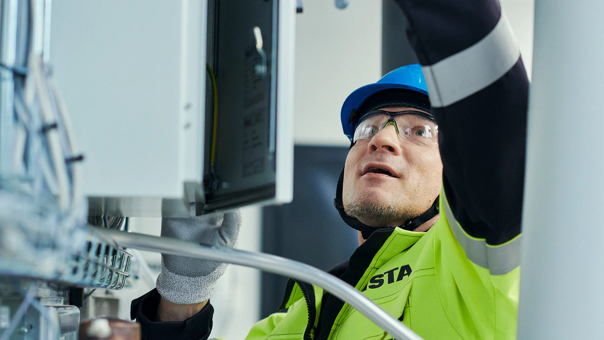 Maintenance and servicing work on electrical distribution equipment, with inspection of an electrical cabinet and connected wiring.