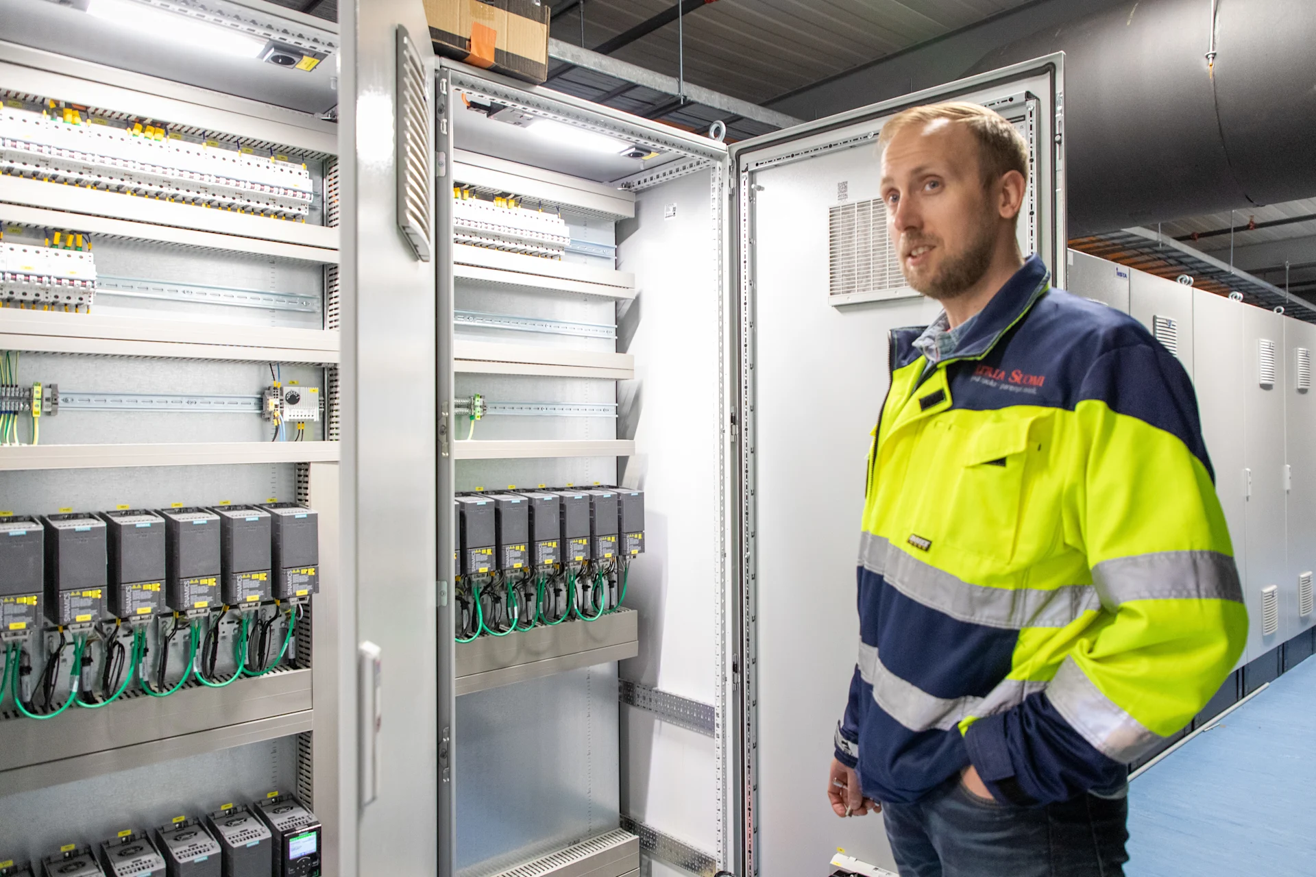 Atria's Pasi Marttila at Nurmo polutry plant alongside Siemens automation technology