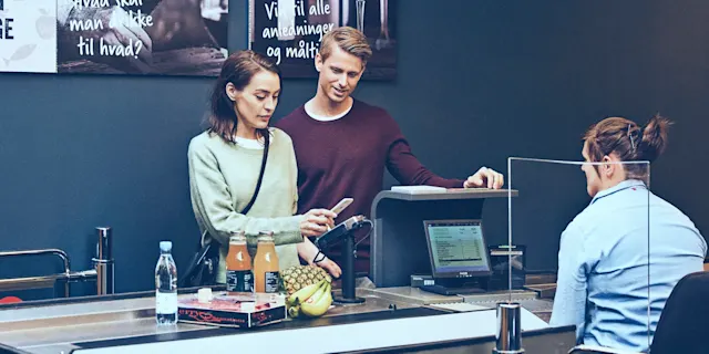 Couple paying with an iPhone