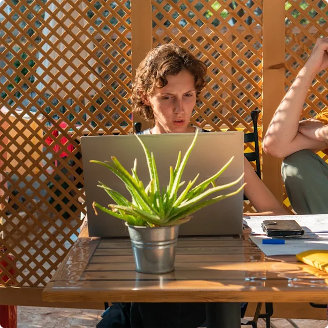 Woman looking at labtop screen with a wondering look.
