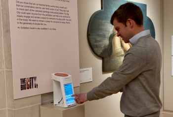 Person making a contactless donation at Guildhall Art Gallery