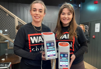 War Child volunteers with CollecTin donation station