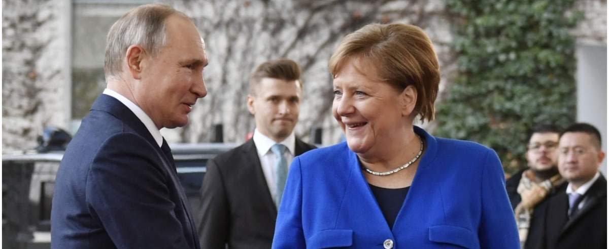 German Chancellor Angela Merkel shakes hands with Russian President Vladimir Putin upon his arrival to attend the Peace summit on Libya at the Chancellery in Berlin on January 19, 2020. - World leaders gather in Berlin on January 19, 2020 to make a fresh push for peace in Libya, in a desperate bid to stop the conflict-wracked nation from turning into a "second Syria". Chancellor Angela Merkel will be joined by the presidents of Russia, Turkey and France and other world leaders for talks held under the auspices of the United Nations. (Photo by John MACDOUGALL / AFP)