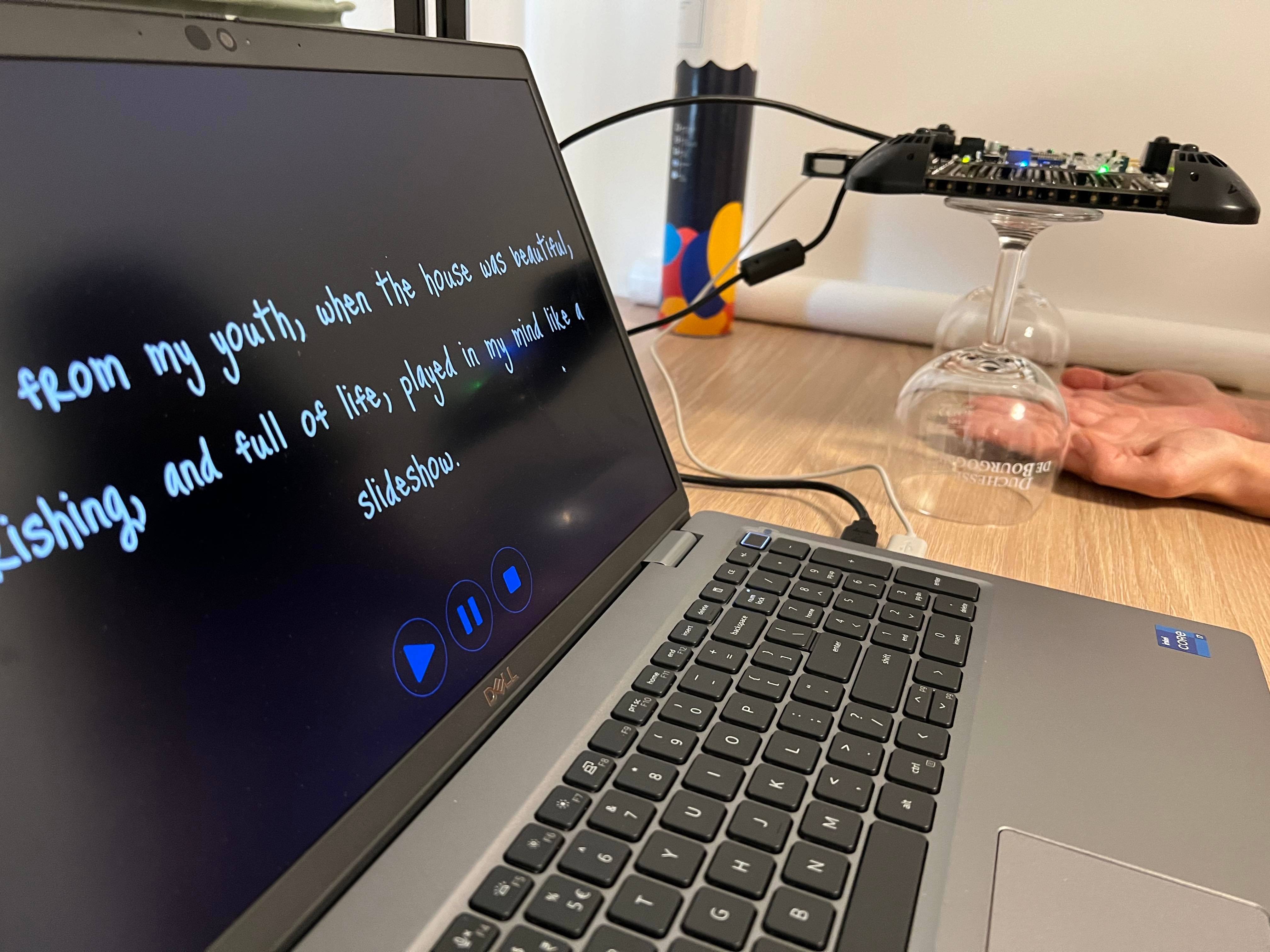 The author is texting the solution. The photo shows the laptop with the solution interface and the author's palms below the haptic device elevated from the table to 20cm height.