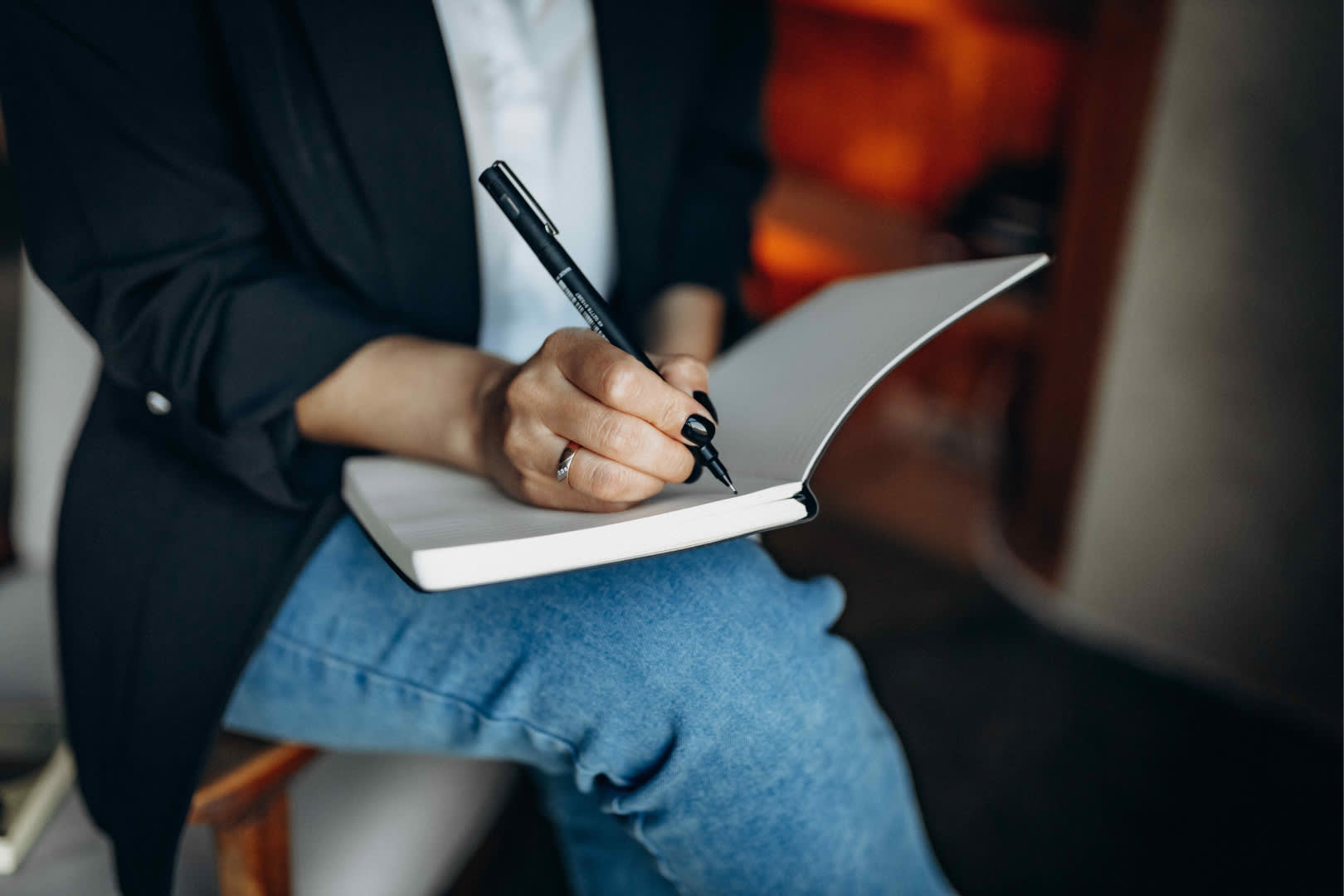 Author is writing in notebook.
