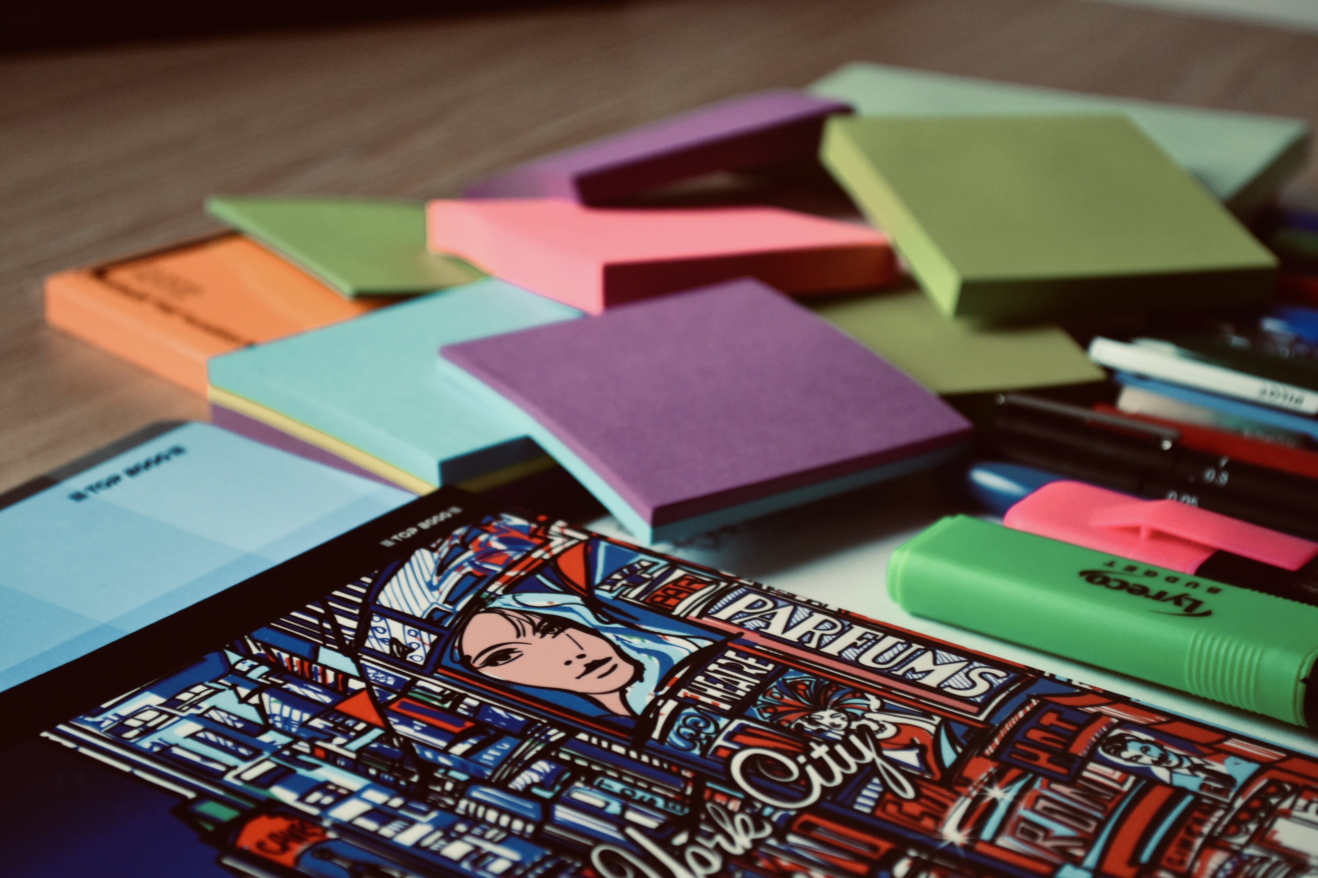 Colorful sticky notes and markers lying on the table.