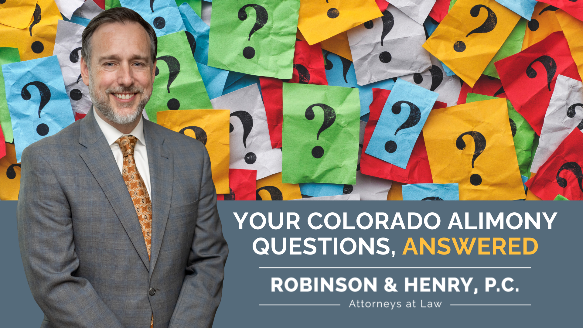 A professional headshot of a smiling, middle-aged man with grey hair and a beard, wearing a grey suit and an orange-patterned tie. He is positioned in front of a background covered in colorful sticky notes with black question marks. A grey text box in the corner reads: 