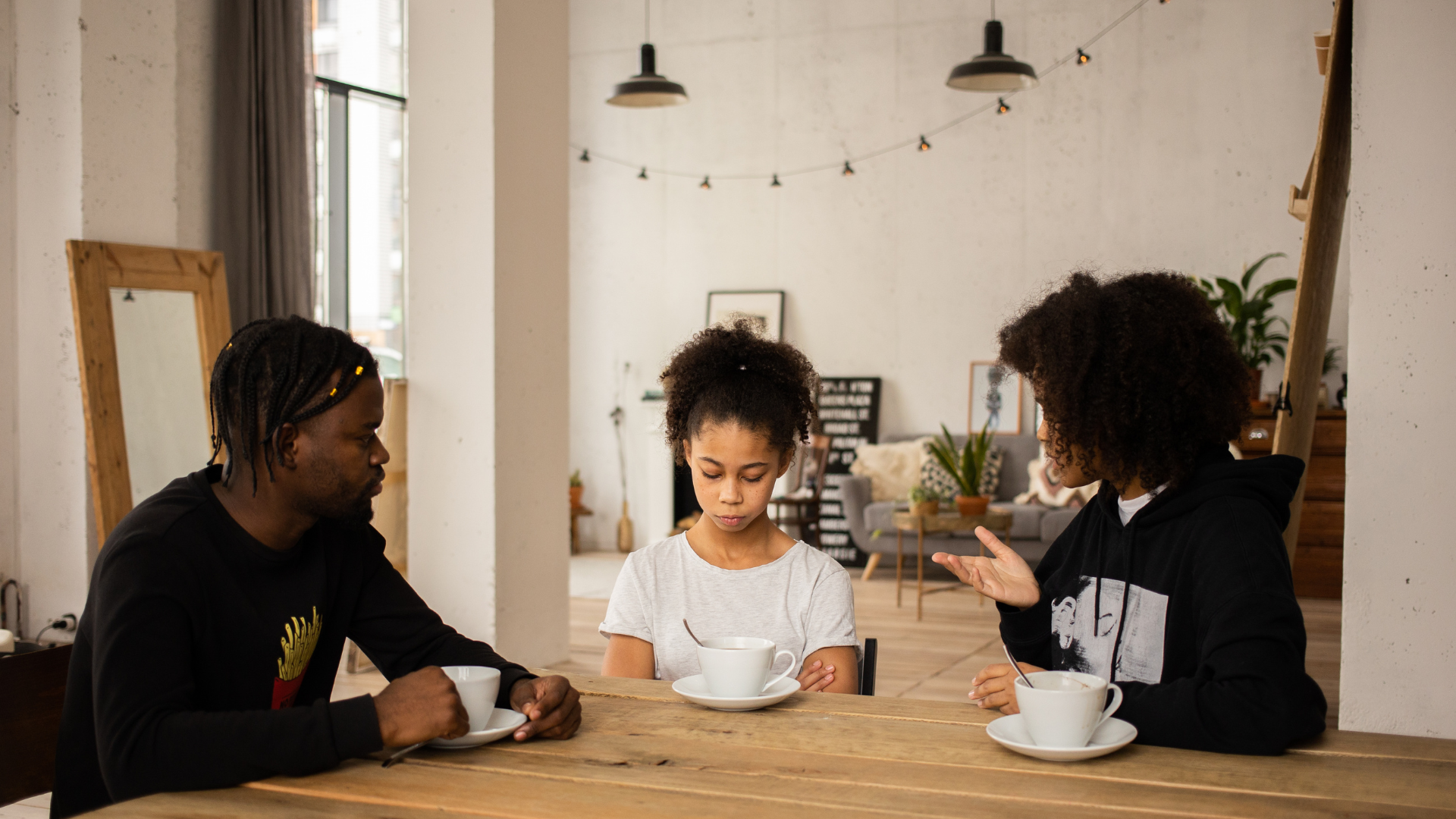 Parents talk with their daughter about a serious topic.