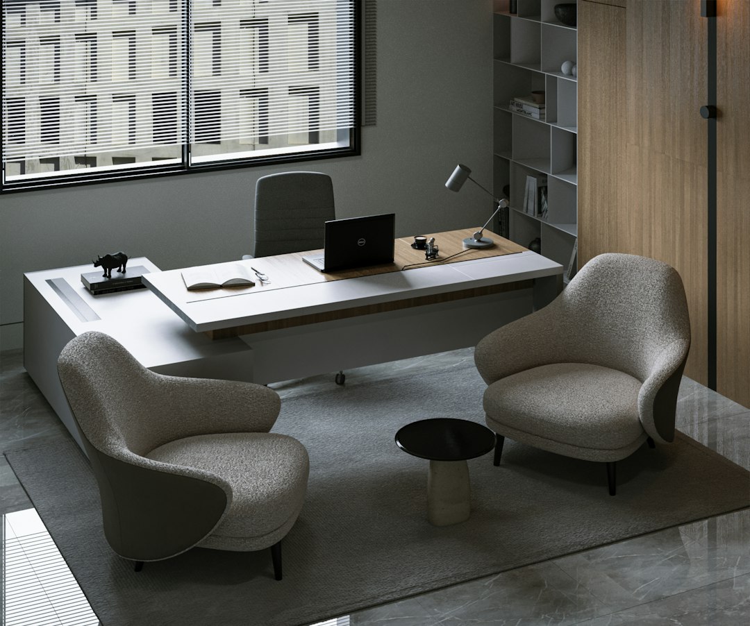 a desk with a chair and a laptop on it