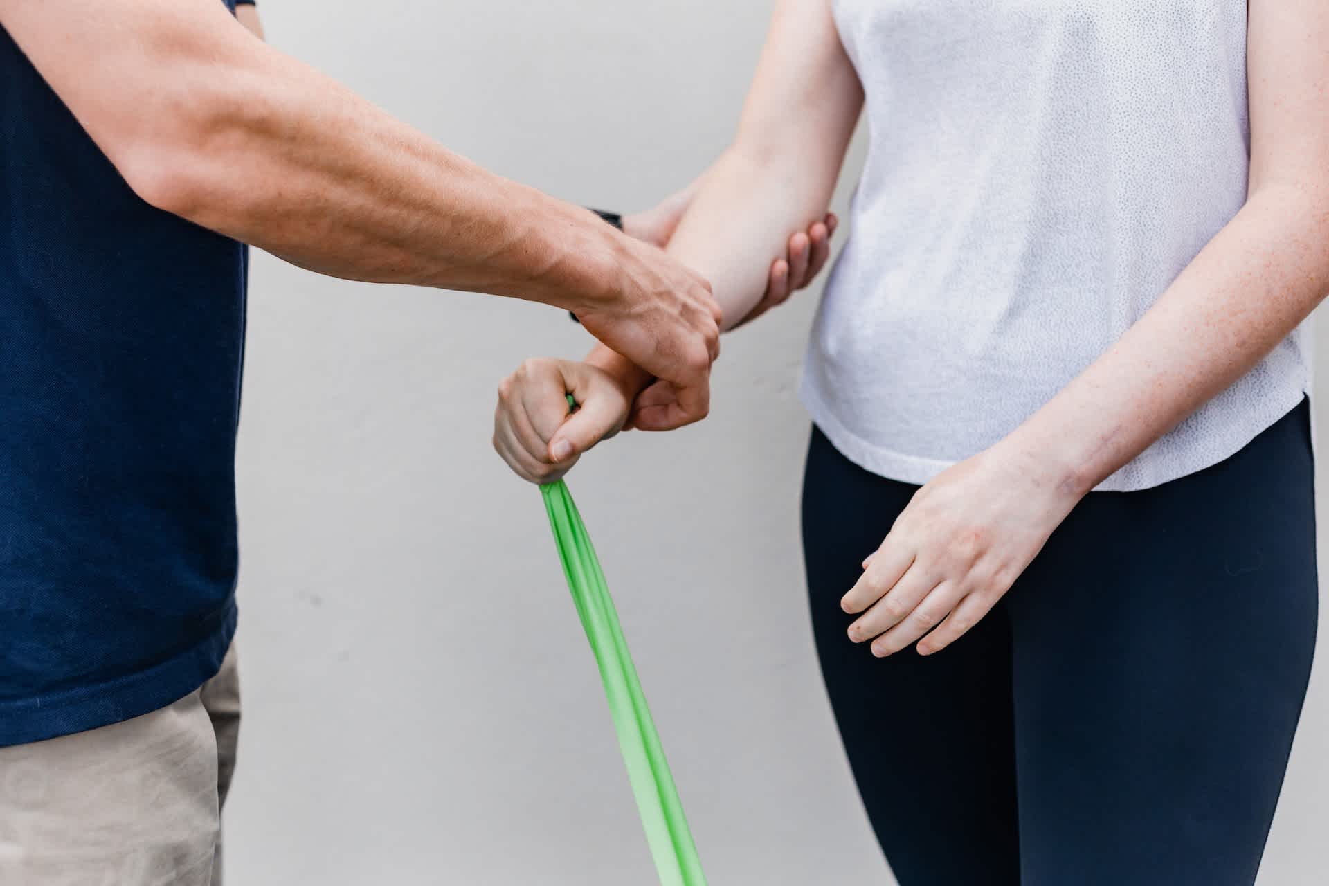 Physiotherapist Working on Woman's Arm