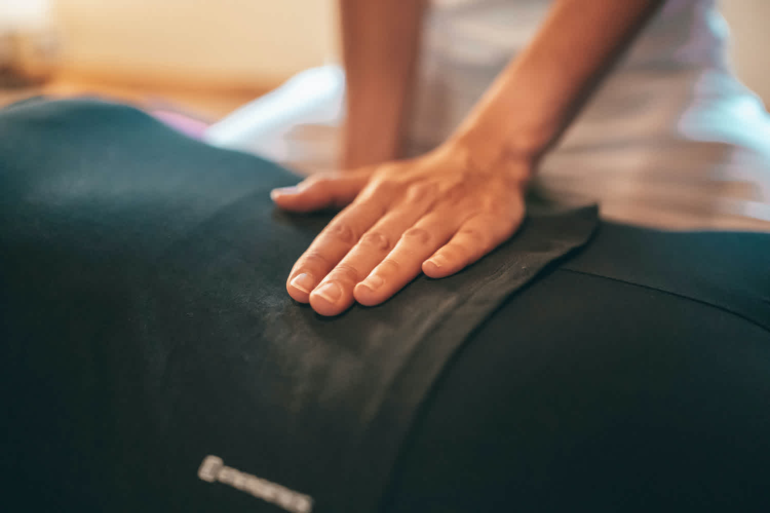 Occupational therapist touching patient back