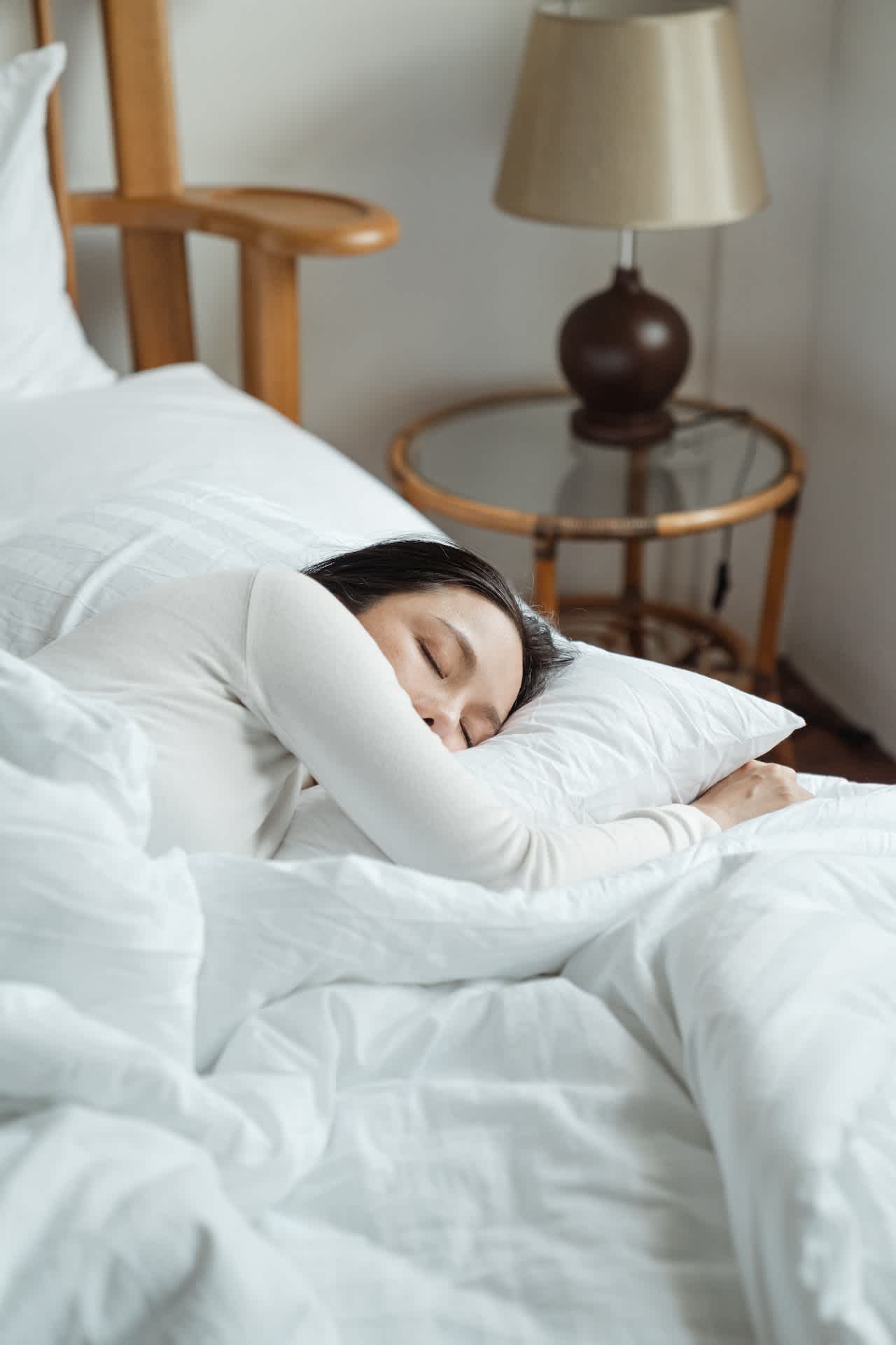 Woman sleeping on white linen