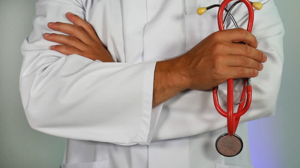 Doctor standing with stethoscope 