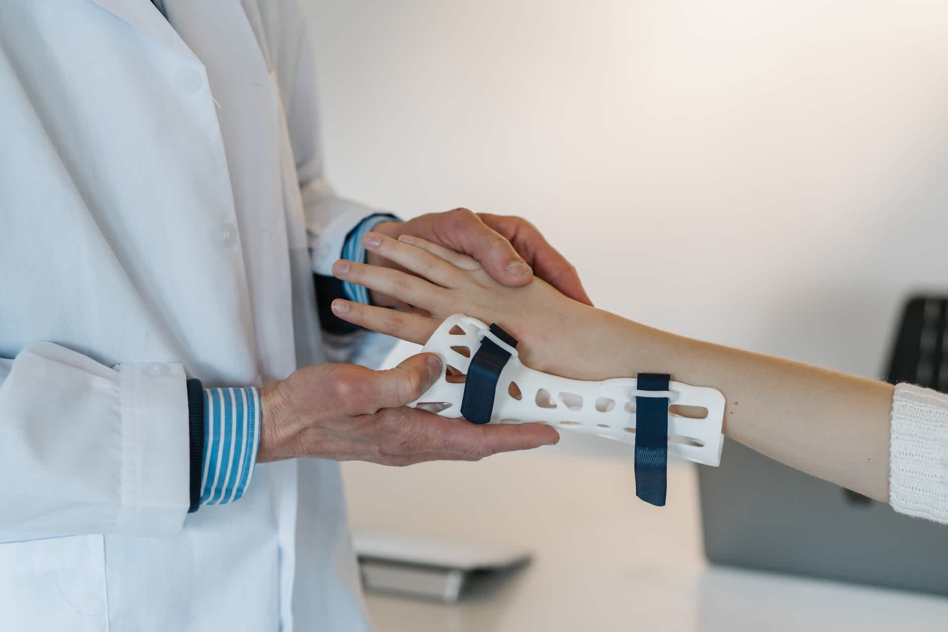 Doctor putting a brace on an injured wrist