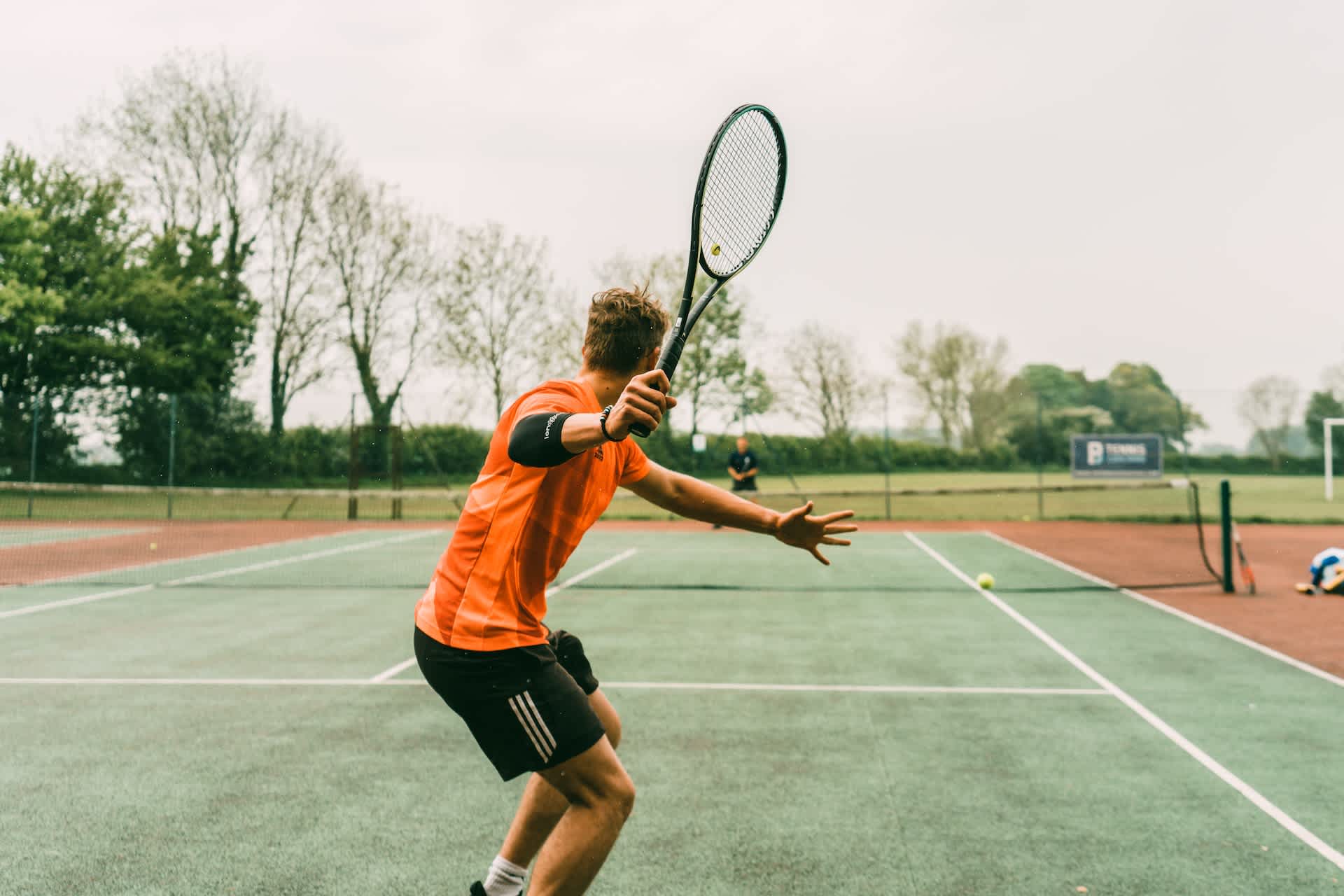 male tennis player on clay court