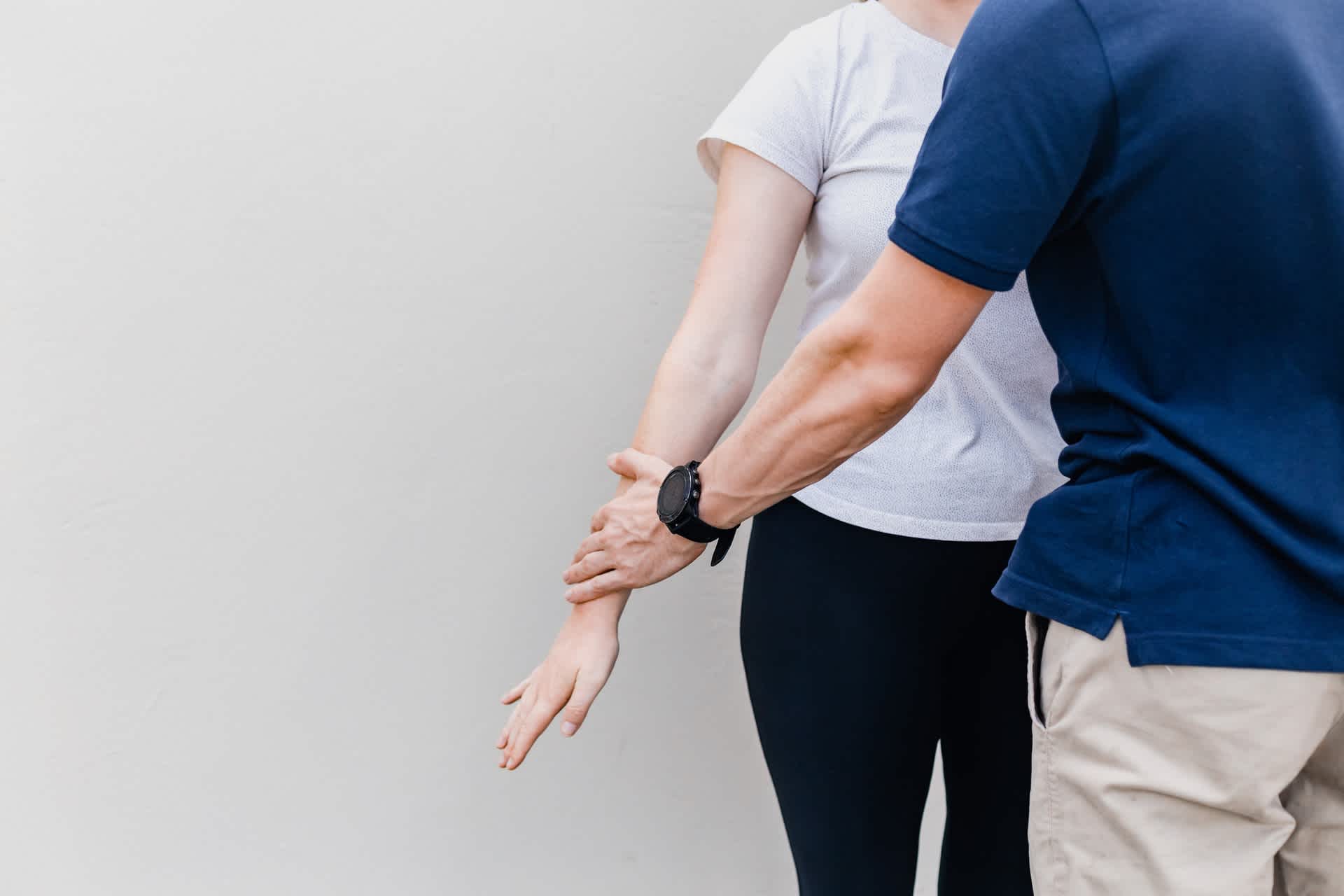 Physiotherapist working with woman's arm