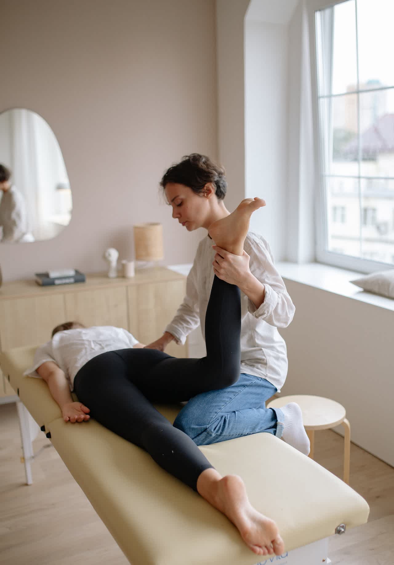 Massage therapist working on woman's leg