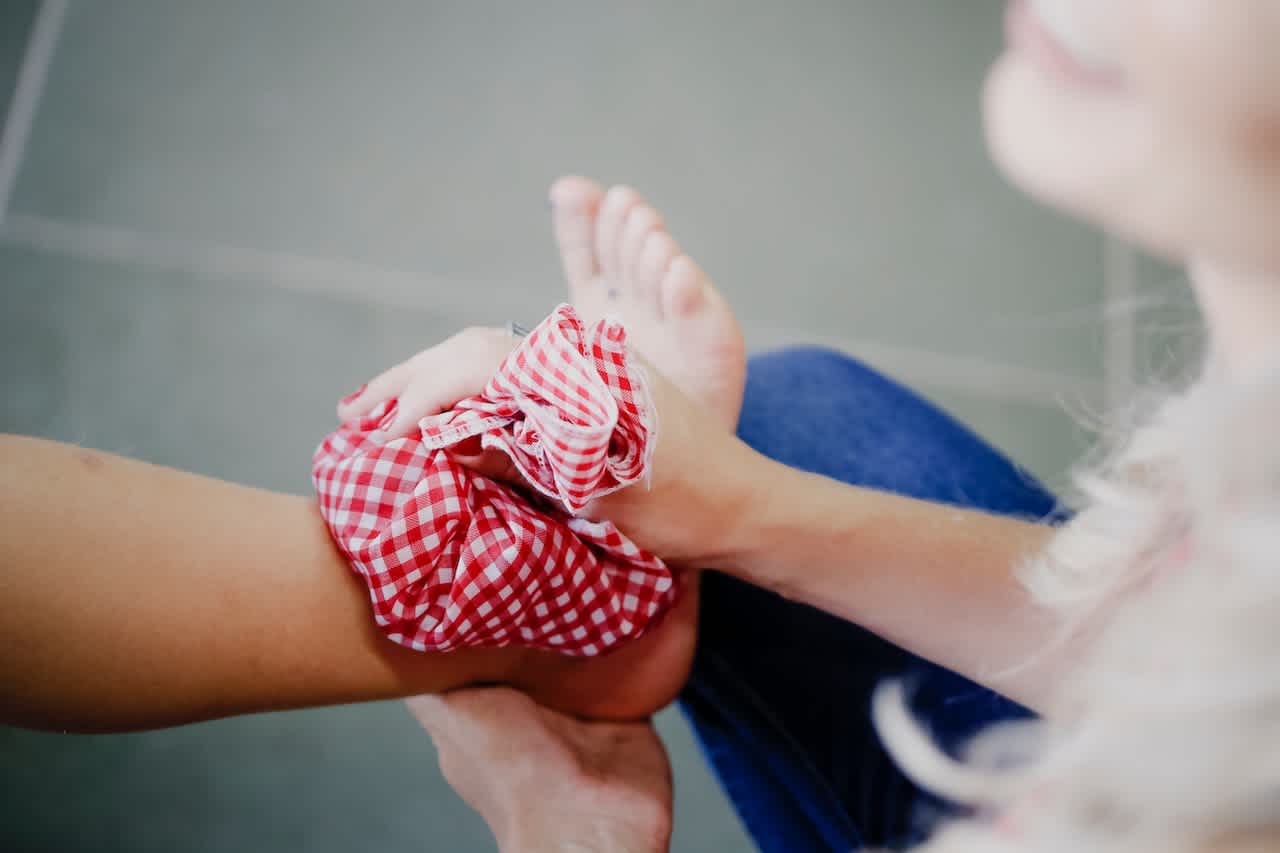 Red gingham ice pack on a person's ankle