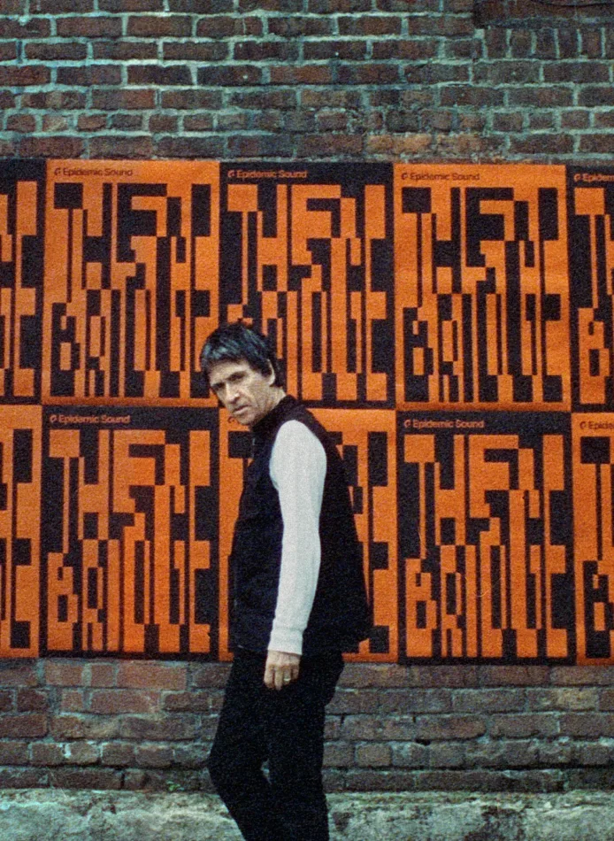 Johnny Marr in front of a brick wall