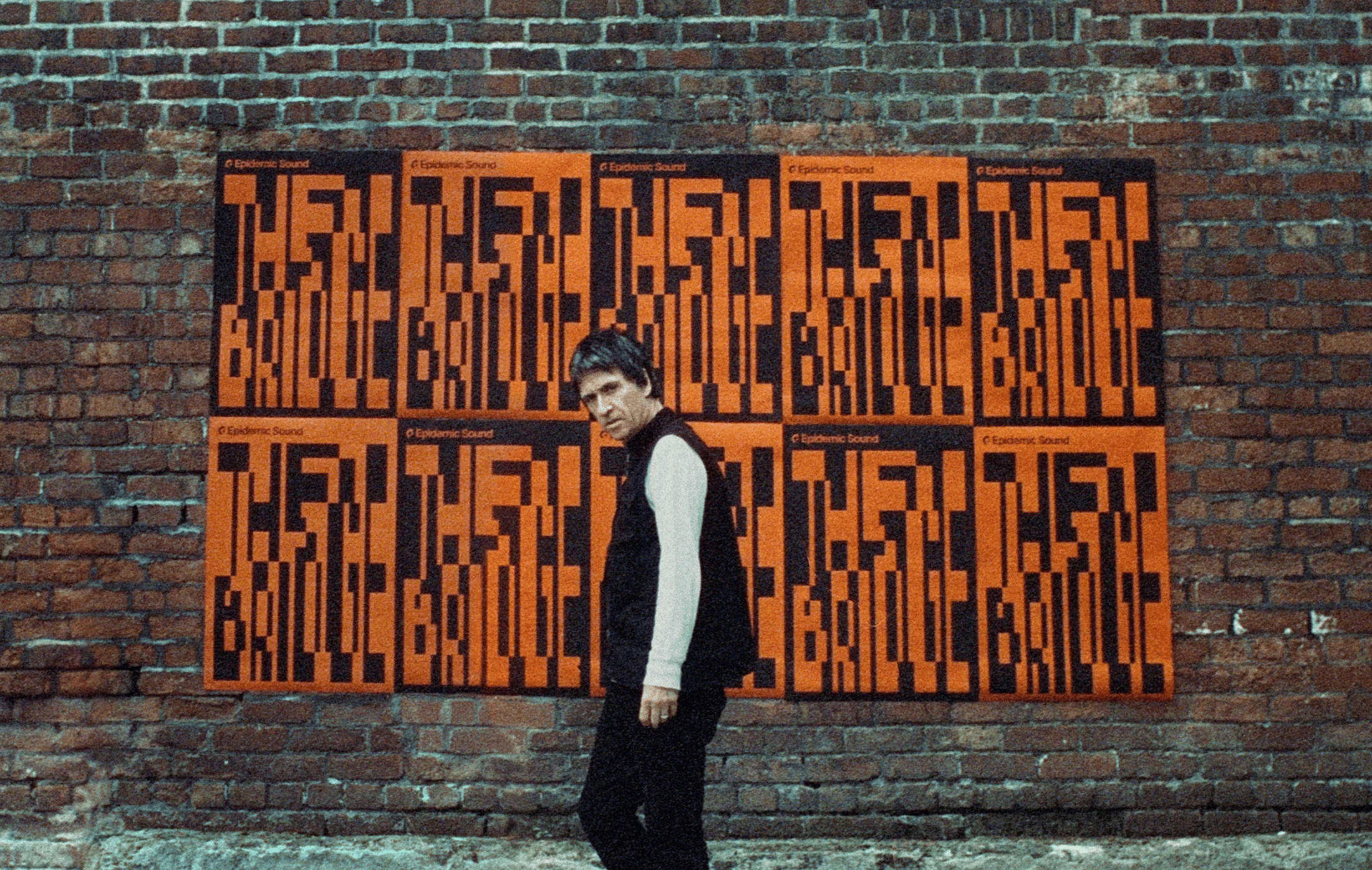 Johnny Marr in front of a brick wall